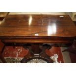 A William IV rosewood tea table on facetted column, quadraform pedestal and scrolled feet 92cm wide