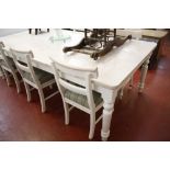 A pine dining table painted with a wash finish 245cm length and a set of six dining chairs