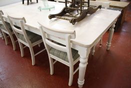 A pine dining table painted with a wash finish 245cm length and a set of six dining chairs