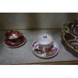 A Dresden cabinet cup and saucer, a cabinet cup and saucer with beehive mark, a Minton cabinet cup