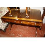 A Regency mahogany sofa table, circa 1815, the rectangular top with rounded corners to the fall-