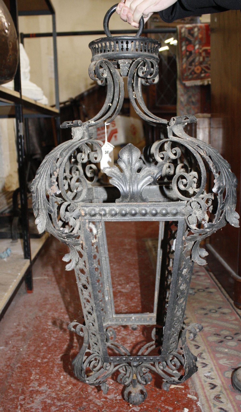 A black painted wrought-iron lantern in the Continental 18th century style