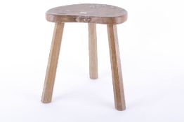A Mouseman oak three legged stool