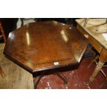 A Victorian mahogany octagonal centre table, on reeded turned pillars and four reeded sabre legs,