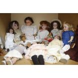 A small collection of early 20th century English and Continental dolls, a small rocking horse and