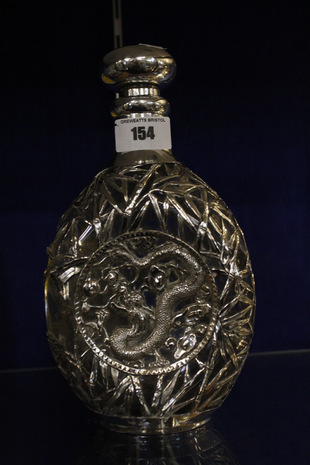 A Chinese clear glass and silver mounted decanter, decorated with dragon, marked Tientsin Yechig