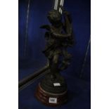 A Victorian spelter figure of a cherub on wooden plinth base, 39cm high