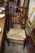 A set of Lancashire type stained beech spindle back dining chairs with shell carved toprail and rush