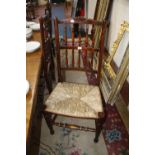 A set of Lancashire type stained beech spindle back dining chairs with shell carved toprail and rush