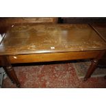 An oak side table with a drawer at either end on facetted tapering legs 115cm wide Best Bid