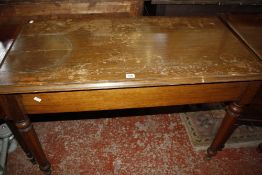 An oak side table with a drawer at either end on facetted tapering legs 115cm wide Best Bid
