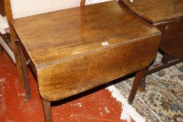 A George III mahogany Pembroke table, the rounded rectangular twin flap top above a frieze drawer,