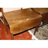 A George III mahogany Pembroke table, the rounded rectangular twin flap top above a frieze drawer,