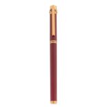 Cartier, Must de Cartier, a red lacquer fountain pen, with gold plated detail  Cartier, Must de