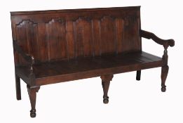 A George III oak settle, late 18th century and later  A George III oak settle,   late 18th century