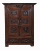 A Continental carved oak cupboard, mid 18th century  A Continental carved oak cupboard,   mid 18th