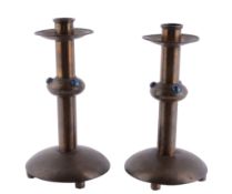 A pair of Arts and Crafts patinated brass candlesticks, circa 1910  A pair of Arts and Crafts