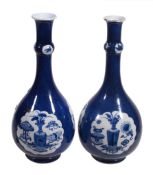 A pair of Chinese blue and white powder-blue ground bottle vases, Kangxi A pair of Chinese blue