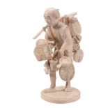 An Ivory Okimono of a Basket Seller , he stands on an oval base as he walks... An Ivory Okimono of a