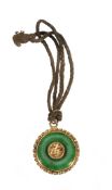 A small Chinese green jade and gold circular pendant, circa 1900-1920 A small Chinese green jade and