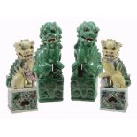 A pair of Chinese Famille Verte models of Buddhistic Lions A pair of Chinese Famille Verte models of