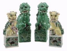 A pair of Chinese Famille Verte models of Buddhistic Lions A pair of Chinese Famille Verte models of
