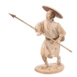 An Ivory Okimono of a Fisherman, he stands with one foot in front of the... An Ivory Okimono of a