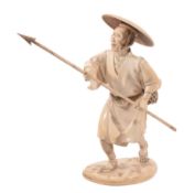 An Ivory Okimono of a Fisherman, he stands with one foot in front of the... An Ivory Okimono of a