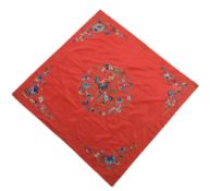A Chinese red silk embroidered square, 19th century A Chinese red silk embroidered square, 19th