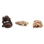 An Ivory Netsuke carved in the form of two boys scrambling out from under a... An Ivory Netsuke
