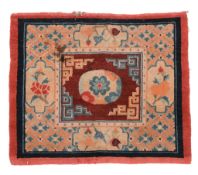 A Tibetan Seating Mat woven with a central floral motif within key-fret... A Tibetan Seating Mat