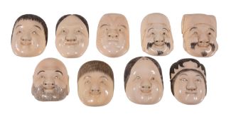 A Group of Ivory Noh Masks and Other Characters including Okame, Hotei, Ebisu A Group of Ivory Noh