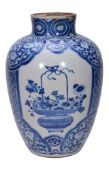 A Chinese blue and white vase, Kangxi, painted with three panels of a vase... A Chinese blue and