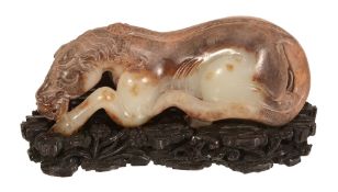 An attractive Chinese celadon and russet jade horse, 19th or 20th century An attractive Chinese