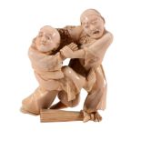An Ivory Okimono of Two Blind Men , the figures stand grappling with one... An Ivory Okimono of