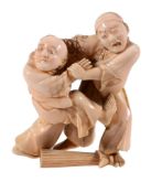 An Ivory Okimono of Two Blind Men , the figures stand grappling with one... An Ivory Okimono of
