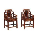 A pair of Chinese hall chairs , each with scroll motifs around central... A pair of Chinese hall