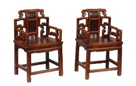 A pair of Chinese hall chairs , each with scroll motifs around central... A pair of Chinese hall