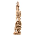 A Walrus Ivory Okimono of a fisherman seated on a rock beneath which a... A Walrus Ivory Okimono