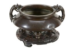 A Chinese silver-inlaid bronze tripod two-handled censer A Chinese silver-inlaid bronze tripod two-