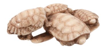 Tomochika: An Ivory Netsuke carved as four turtles gathered around and on... Tomochika: An Ivory