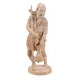 An Ivory Okimono of a Spear Fisherman, he stands on an oval base dressed in... An Ivory Okimono of a