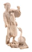 An Ivory Okimono of a Farmer and Goose, the man stands on a rush mat holding... An Ivory Okimono
