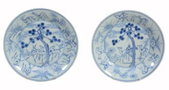 A pair of Chinese blue and white plates, Kangxi, with a 'pencilled A pair of Chinese blue and