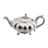 A George IV Scottish silver melon pattern tea pot by J. McKay,   Edinburgh 1829, with a flower and