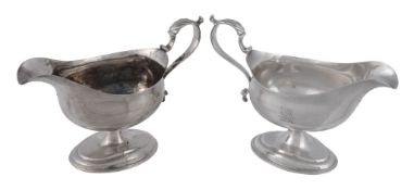 Two similar Georgian silver pedestal sauce boats,   one with overstruck mark by Peter and Ann