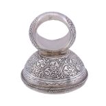 A silver seal ring,   probably 19th century Persian, foliate chased, the circular cornelian matrix