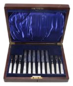 A set of six silver and mother of pearl handled fruit knives and forks by Charles James Allen,