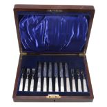 A set of six silver and mother of pearl handled fruit knives and forks by Charles James Allen,