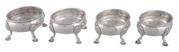 A set of four George III silver oval salt cellars by Robert Hennell I,   London 1772, on four shell